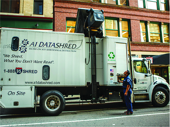 Shredding truck driver performing on site shredding